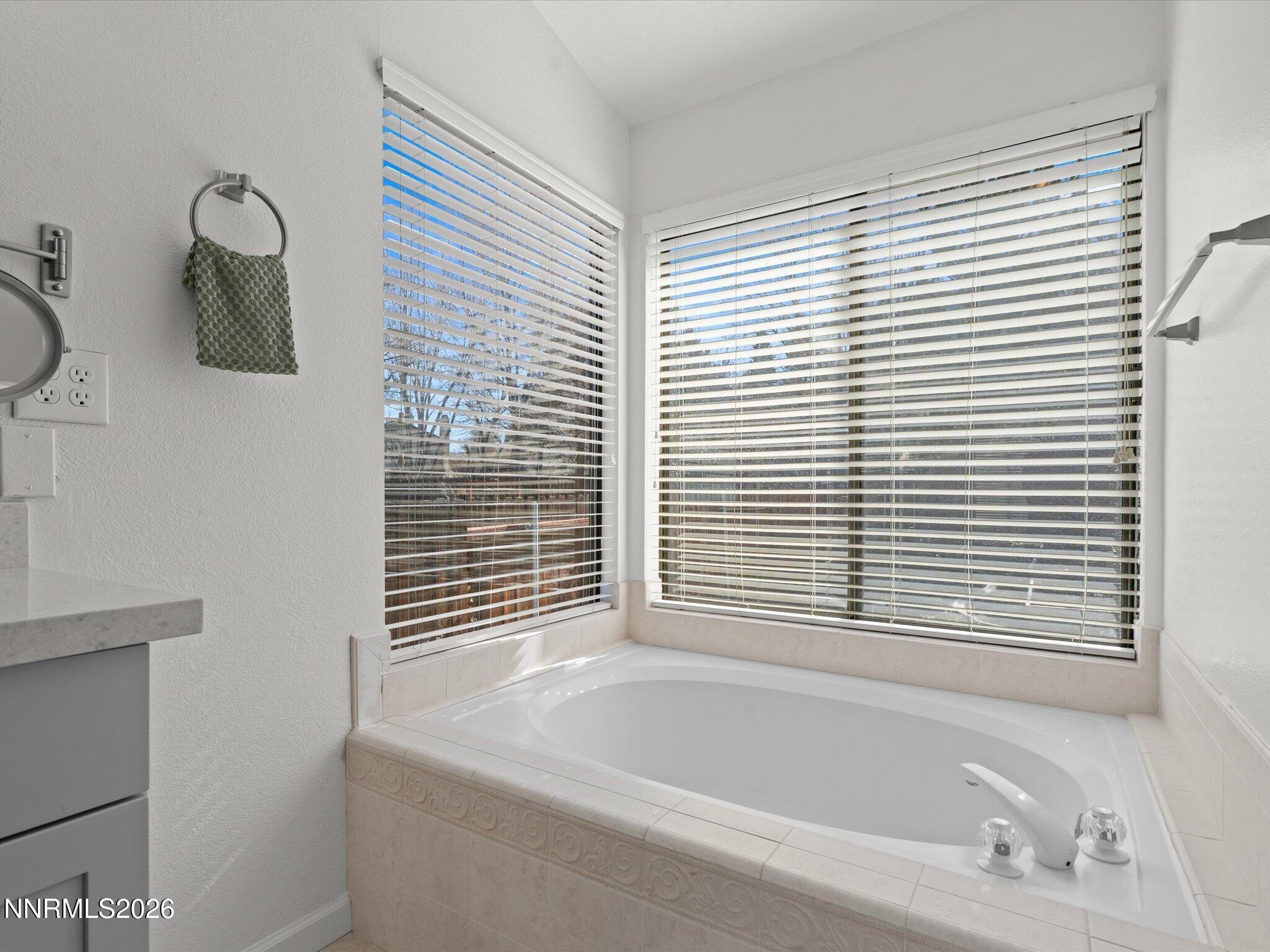 1588 Wheatgrass Drive Reno, NV 89509 - Photo 30 of 42 a bathroom with a bathtub and next to a window