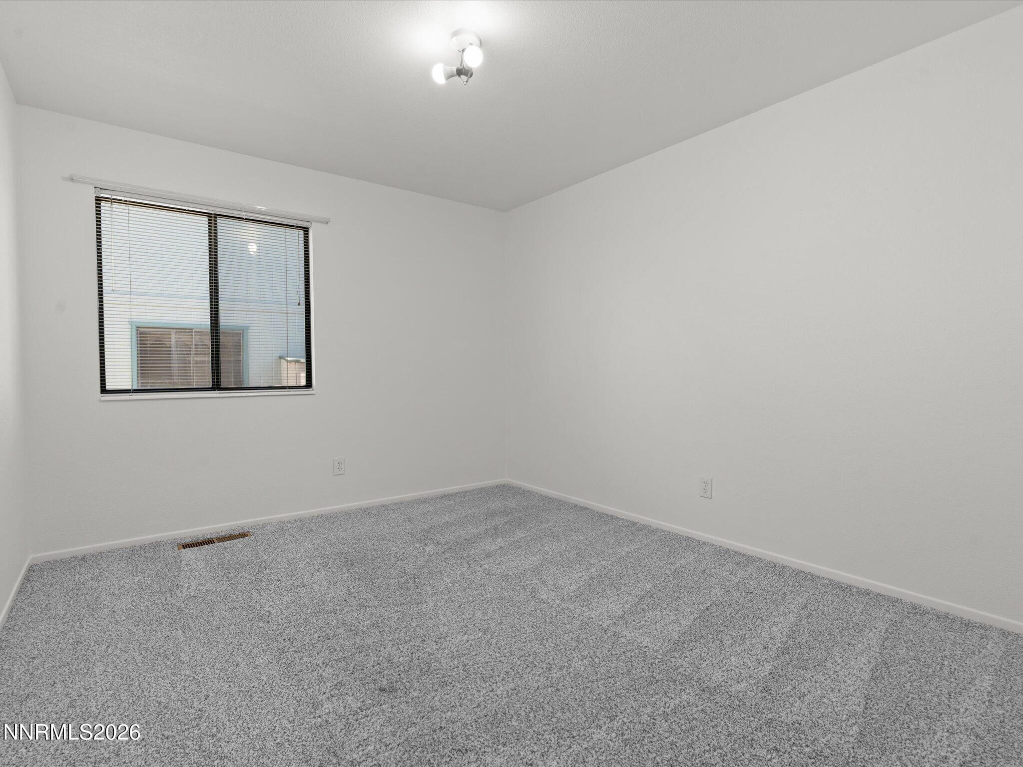 1588 Wheatgrass Drive Reno, NV 89509 - Photo 32 of 42 an empty room with windows