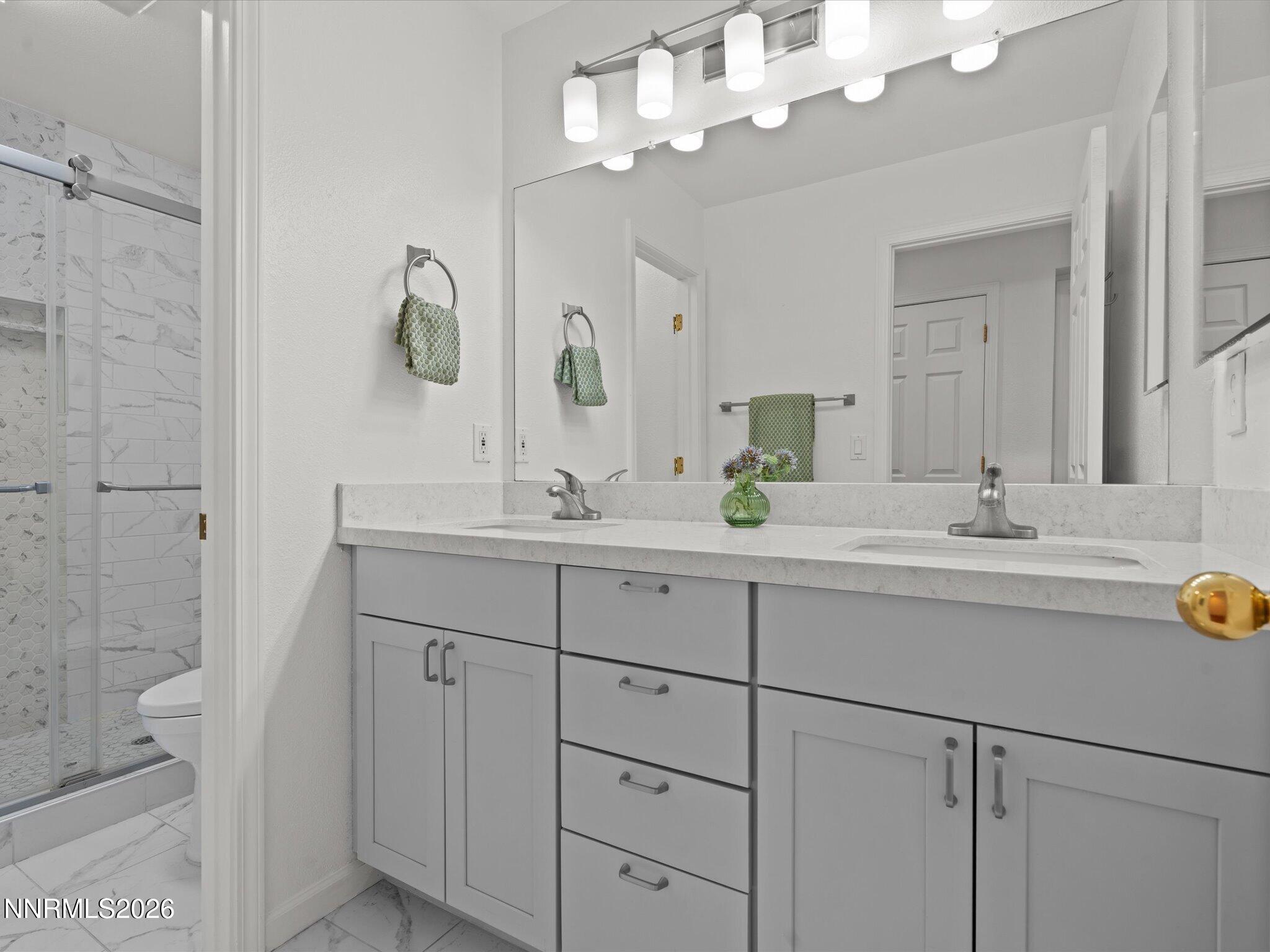 1588 Wheatgrass Drive Reno, NV 89509 - Photo 34 of 42 a bathroom with a double vanity sink mirror and shower