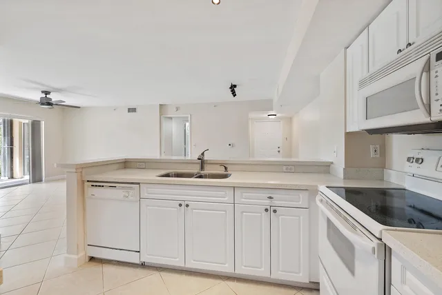 a kitchen with granite countertop a sink and cabinets
