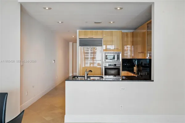 a kitchen with stainless steel appliances granite countertop a sink and a stove