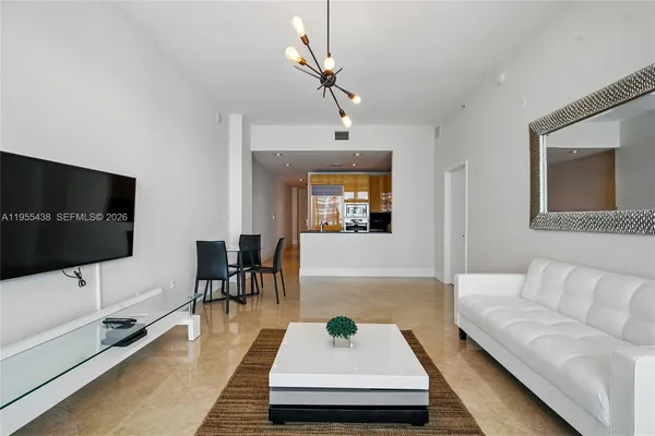a living room with furniture and a flat screen tv