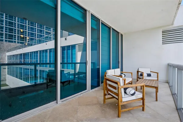a view of a balcony with chair and potted plant