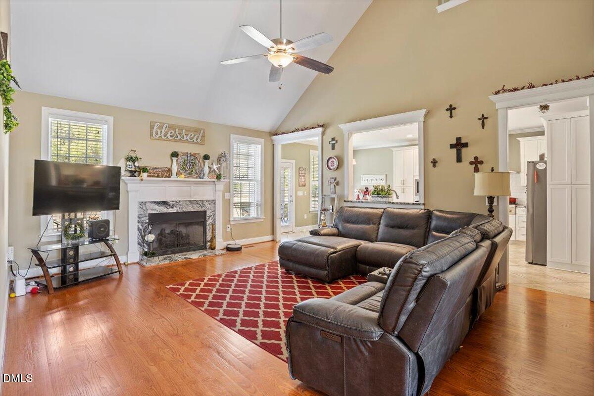 1001 Bellewood Farms Road Raleigh, NC 27603 - Photo 13 of 39 a living room with furniture a fireplace and a flat screen tv