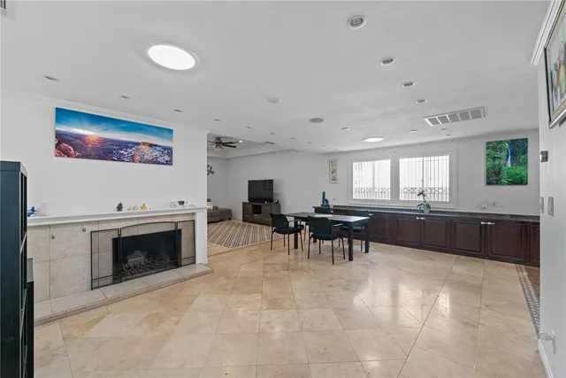 a living room with furniture a fireplace and kitchen view