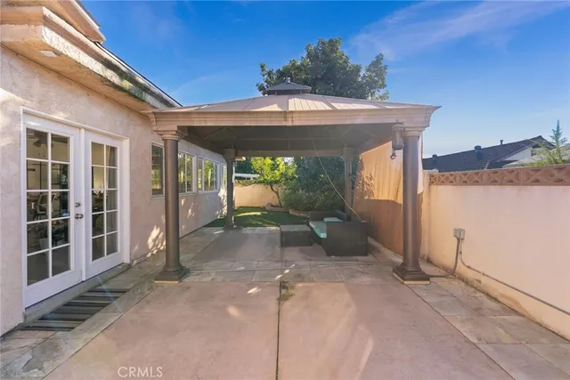 a view of a porch with a hanging from a ceiling fan