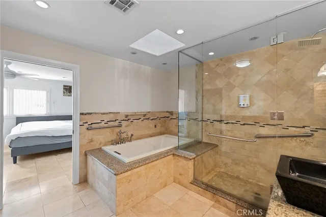 a bathroom with a tub a sink and a shower