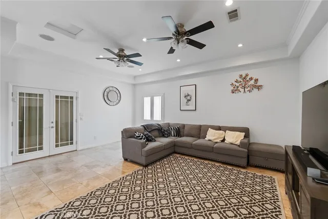 a living room with furniture and a ceiling fan