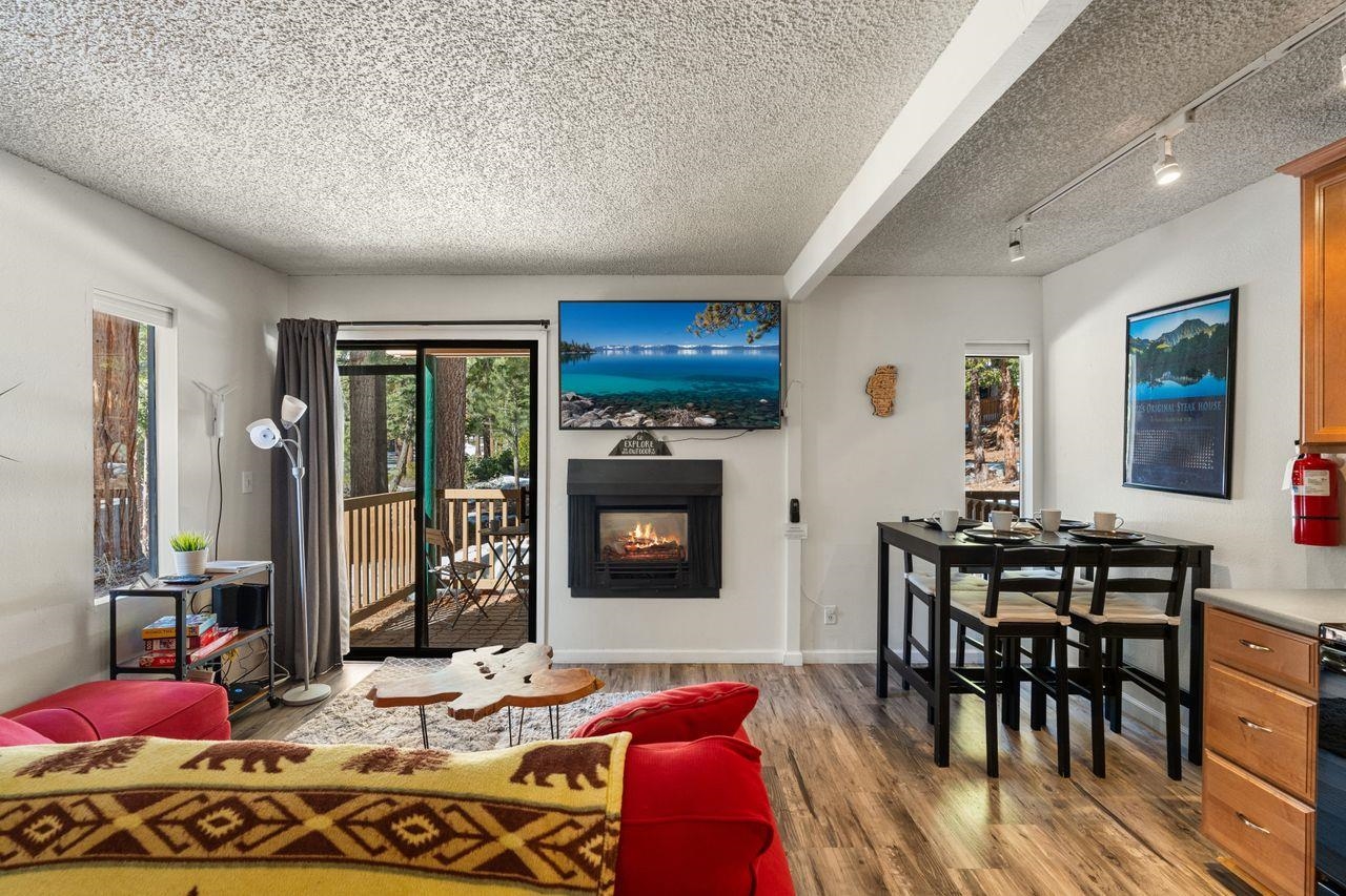 1300 Regency Way, Unit 62 Tahoe Vista, CA 96148 - Photo 11 of 26 a living room with furniture a fireplace and a dining table