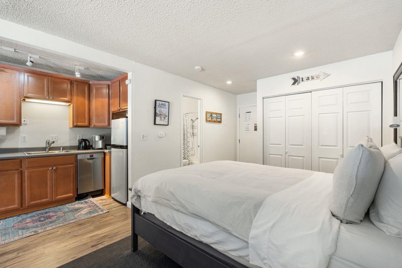 1300 Regency Way, Unit 62 Tahoe Vista, CA 96148 - Photo 15 of 26 a bedroom with a bed and a sink