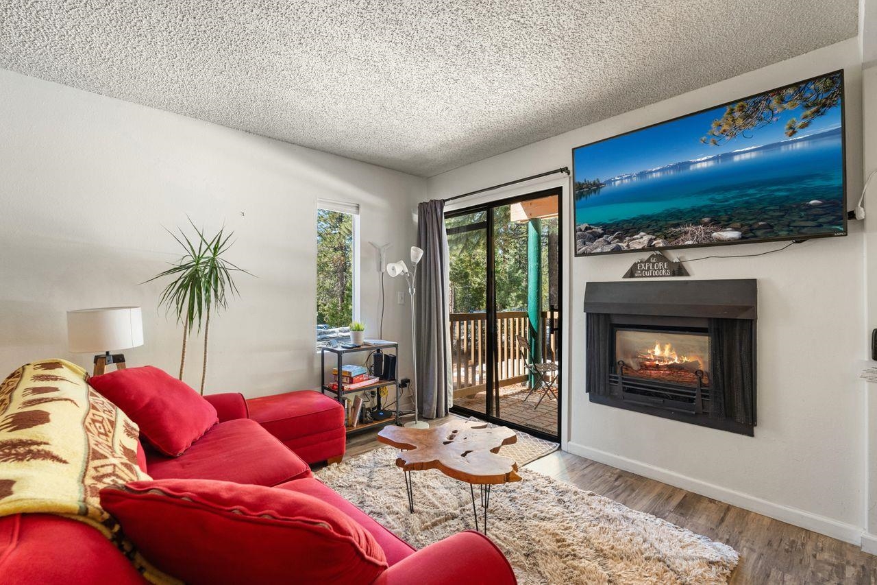 1300 Regency Way, Unit 62 Tahoe Vista, CA 96148 - Photo 4 of 26 a living room with furniture floor to ceiling window and a flat screen tv