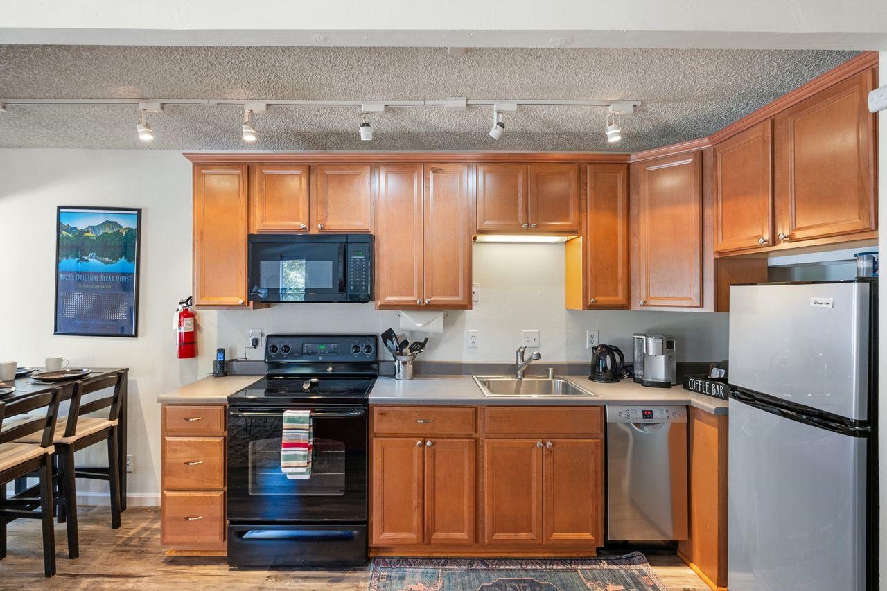 1300 Regency Way, Unit 62 Tahoe Vista, CA 96148 - Photo 8 of 26 a kitchen with stainless steel appliances granite countertop a refrigerator sink and stove