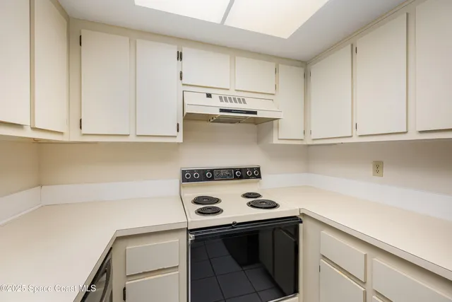 a kitchen with appliances cabinets and a counter top space