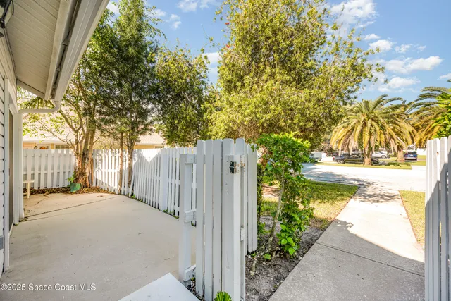 a view of a house with a tree in the background