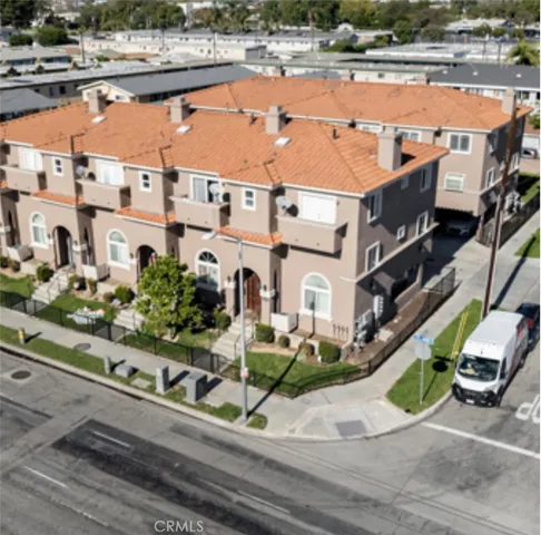 an aerial view of residential houses with outdoor space and parking