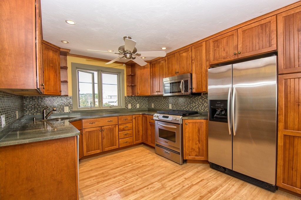 98 Humarock Beach Scituate, MA 02047 - Photo 7 of 14 a kitchen with stainless steel appliances granite countertop a refrigerator a sink and dishwasher