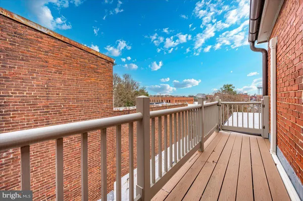 a view of balcony with wooden floor