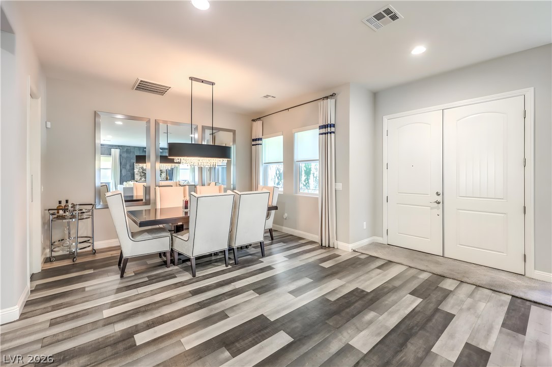 7119 Arabian Ridge Street Las Vegas, NV 89131 - Photo 13 of 73 Hardwood floors and bright windows illuminate this spacious dining area.