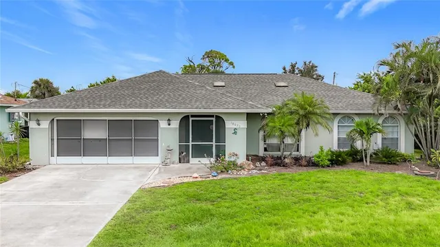 a front view of a house with a garden and plants