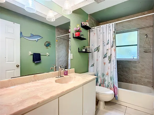 a spacious bedroom with a bed and a book shelf