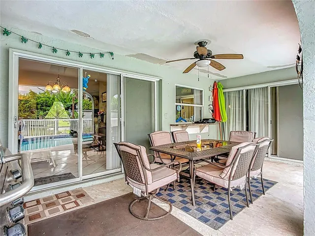 a dining room with furniture a rug and a large window