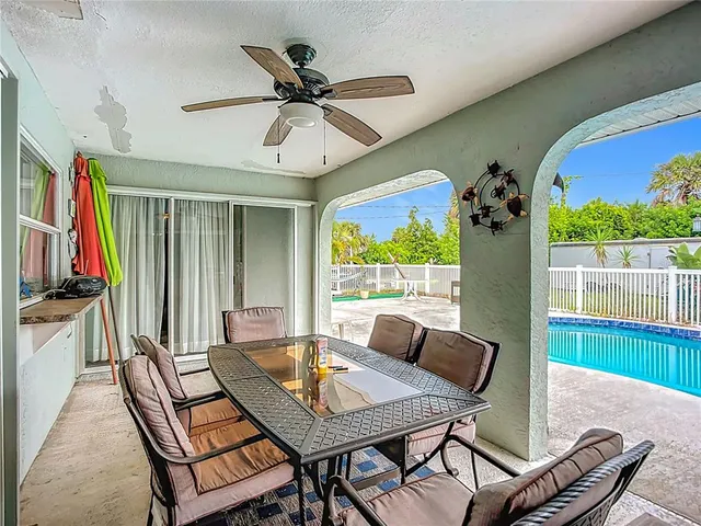 a dining room with furniture a rug and a large window