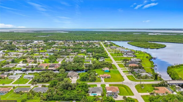 an aerial view of a house with garden space and street view