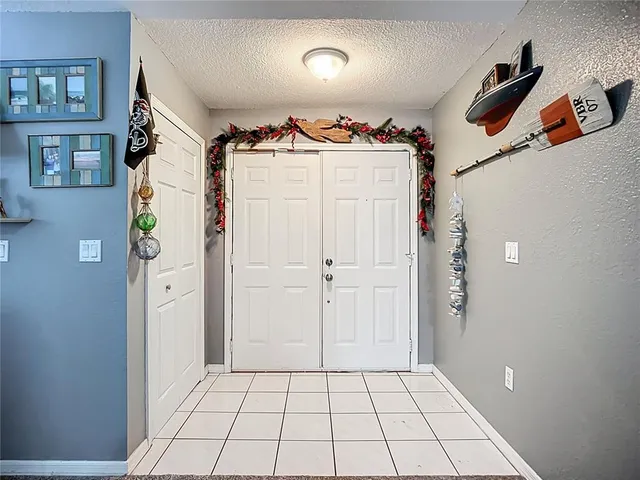 a view of a hallway to rooms and stairs