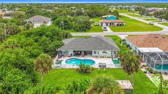 an aerial view of a house with a yard
