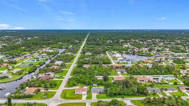 a view of a porch with a dining table and chairs