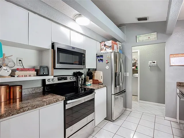 a kitchen with a refrigerator and a sink