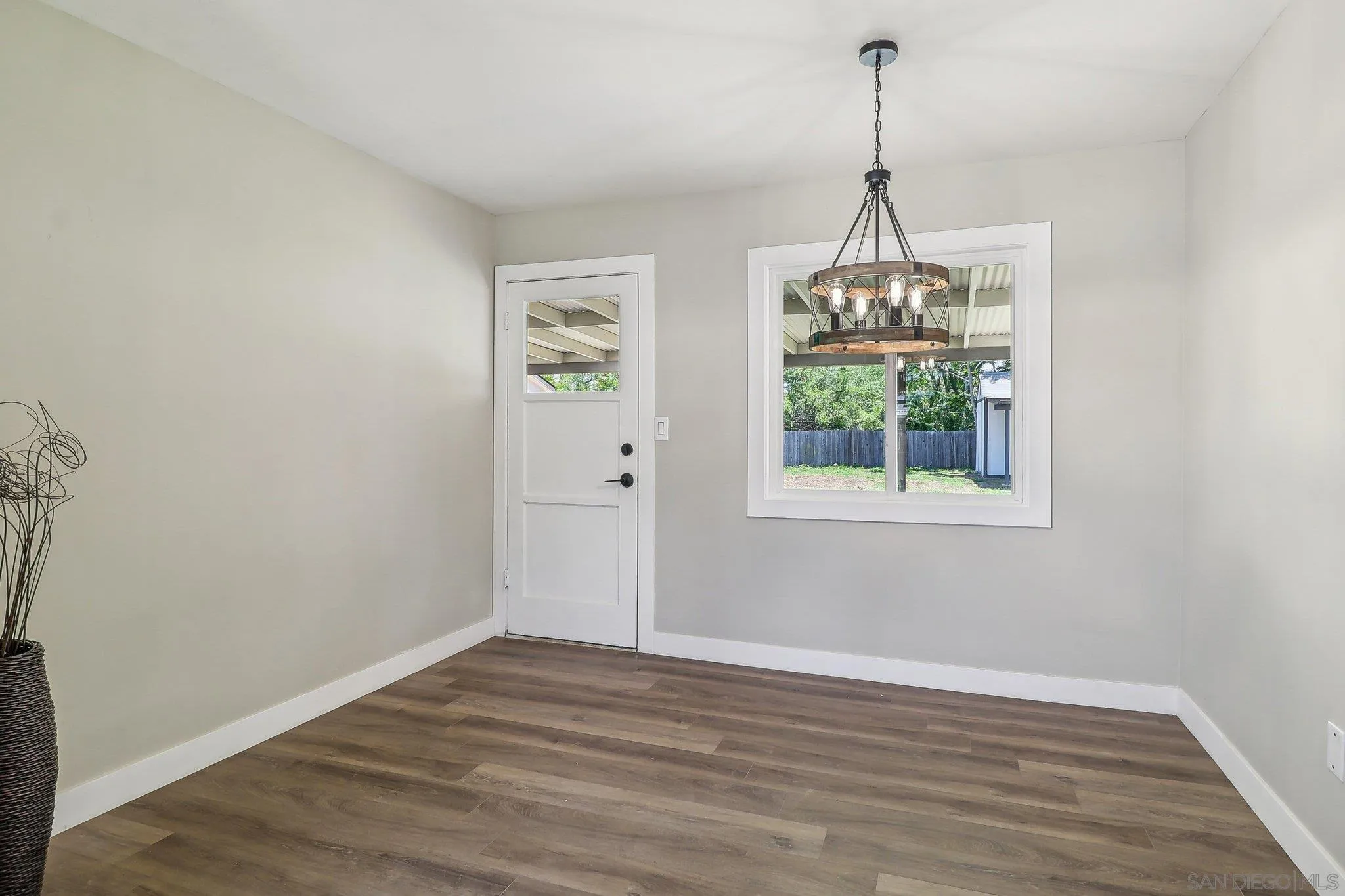 9055 Gorge Avenue Santee, CA 92071 - Photo 12 of 28 a view of an empty room with wooden floor and a window
