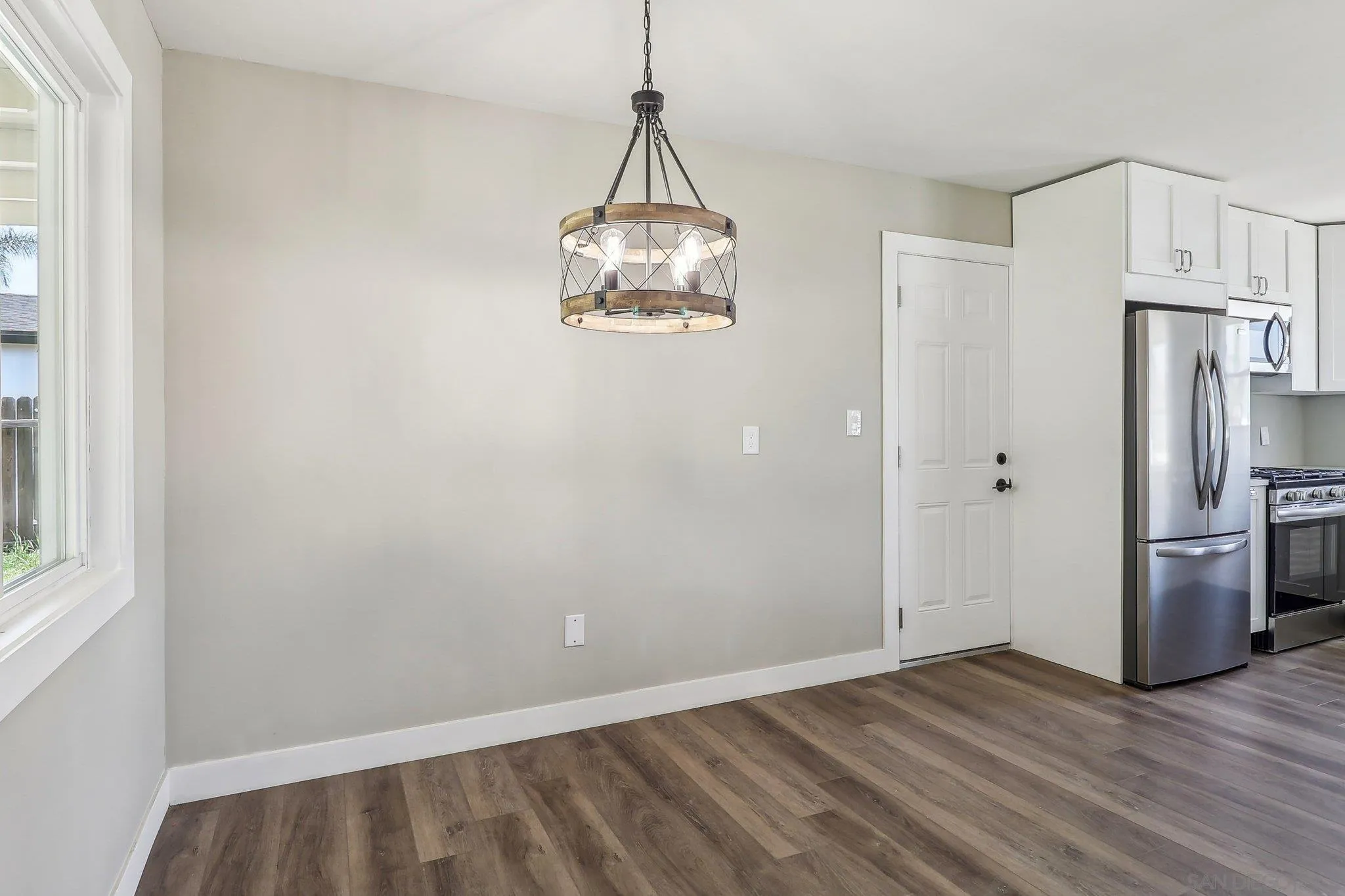 9055 Gorge Avenue Santee, CA 92071 - Photo 13 of 28 a view of a kitchen with a sink refrigerator and wooden floor