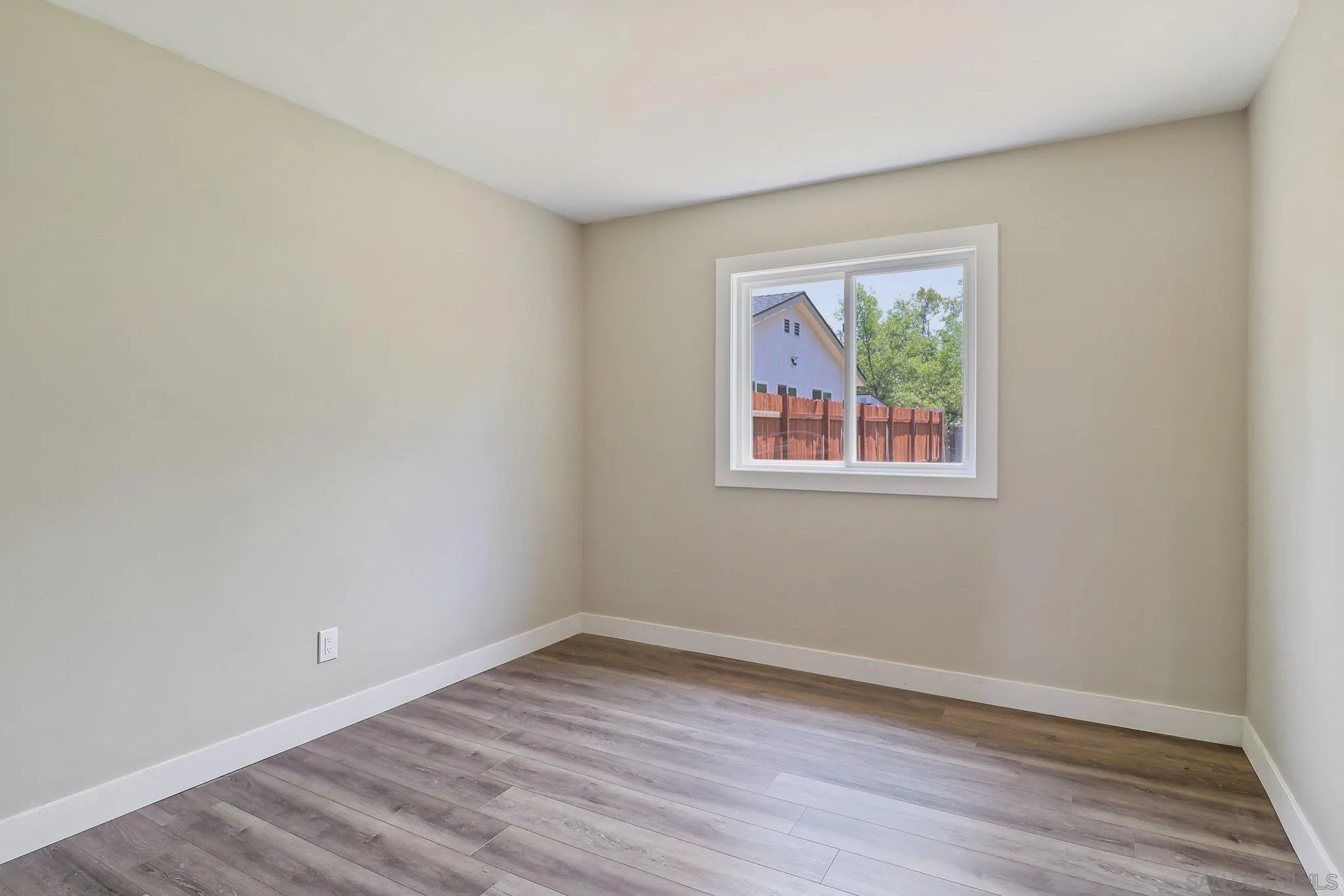 9055 Gorge Avenue Santee, CA 92071 - Photo 17 of 28 a view of an empty room with wooden floor and a window