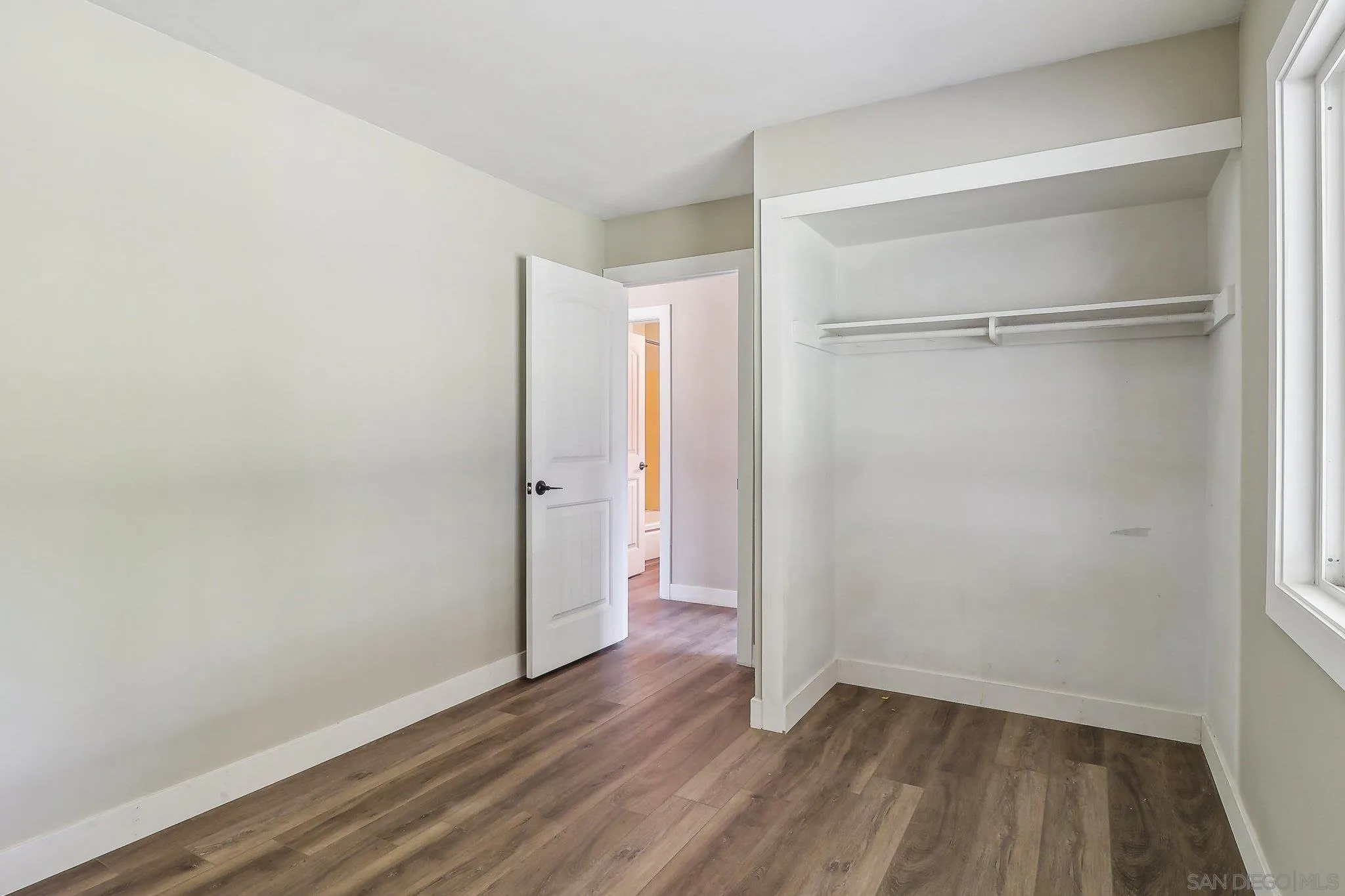 9055 Gorge Avenue Santee, CA 92071 - Photo 19 of 28 a view of an empty room with wooden floor and a window