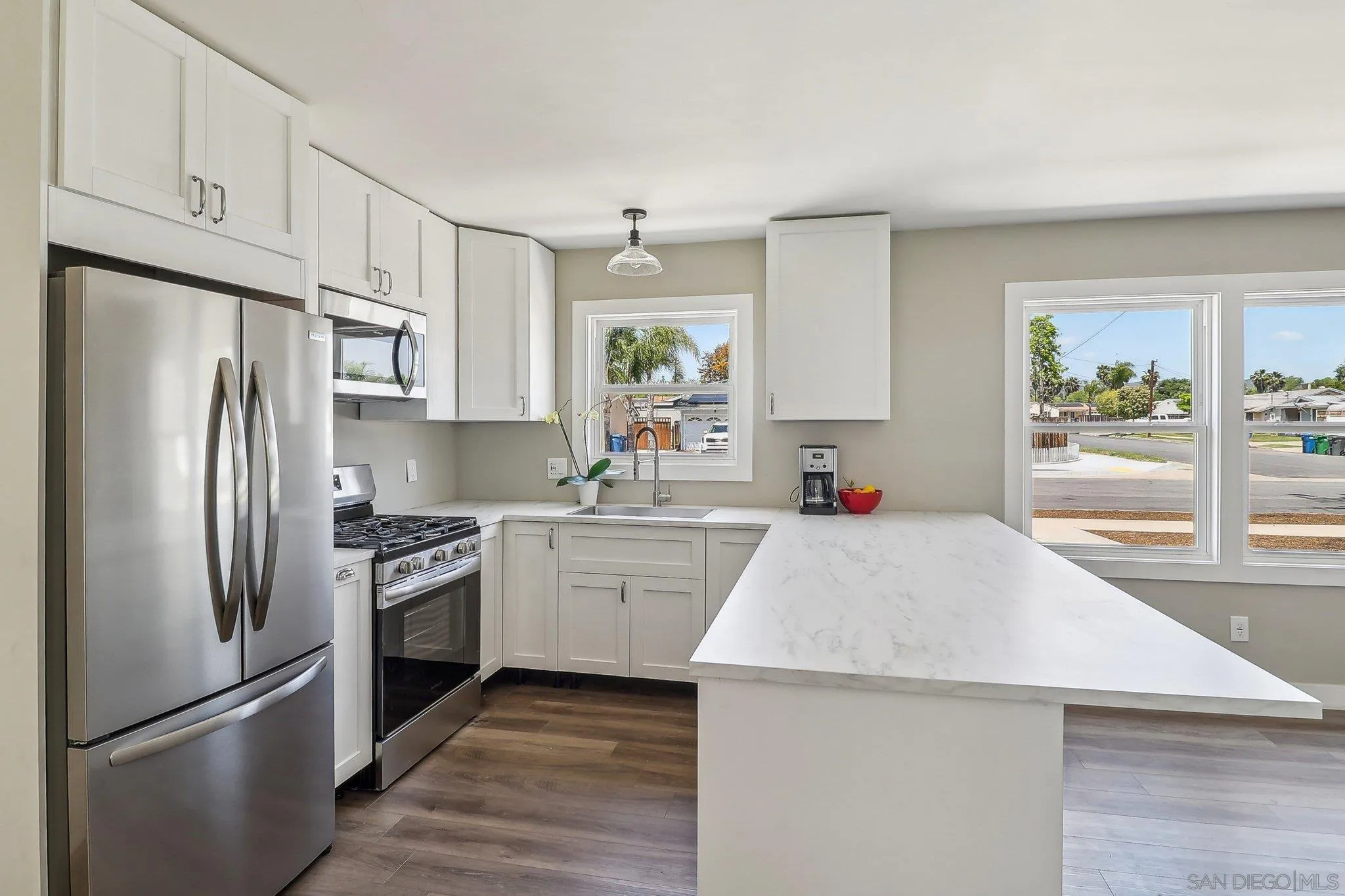 9055 Gorge Avenue Santee, CA 92071 - Photo 9 of 28 a kitchen with stainless steel appliances a refrigerator stove and sink