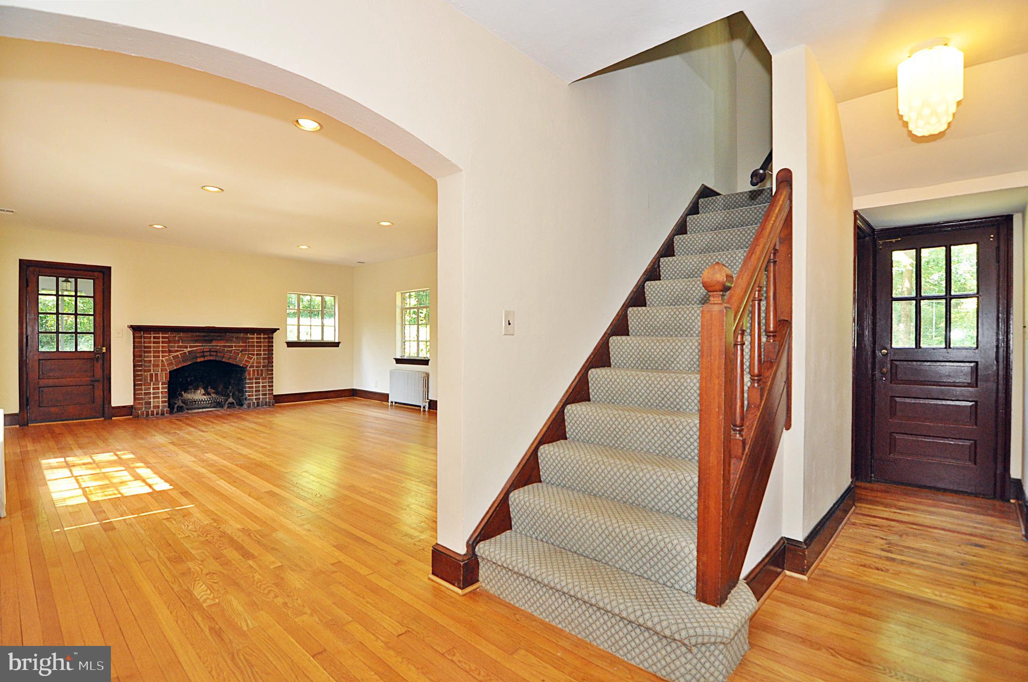 2721 South Arlington Ridge Road Arlington, VA 22202 - Photo 2 of 33 a view of an entryway with wooden floor and a fireplace