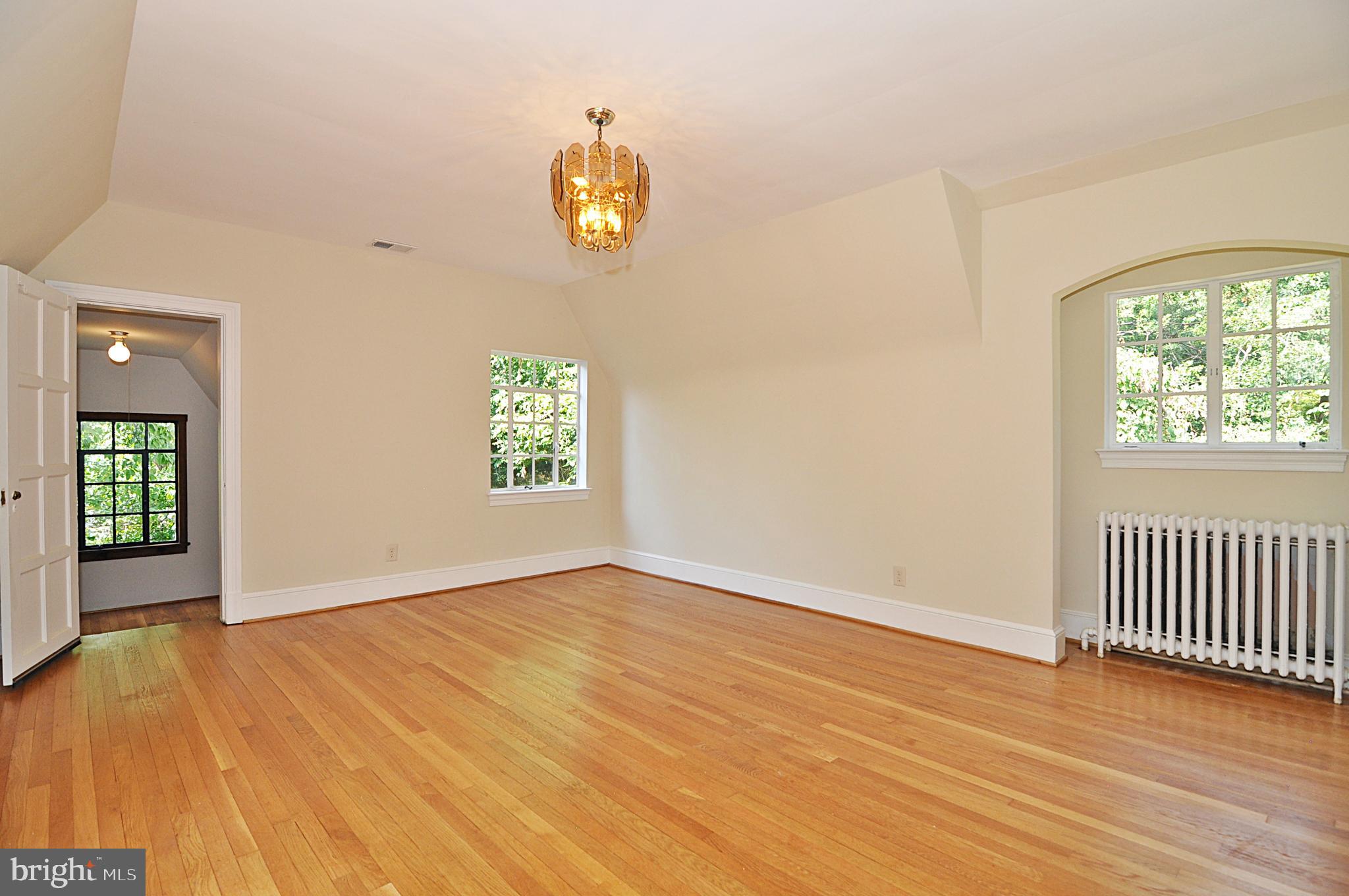 2721 South Arlington Ridge Road Arlington, VA 22202 - Photo 17 of 33 an empty room with wooden floor and windows