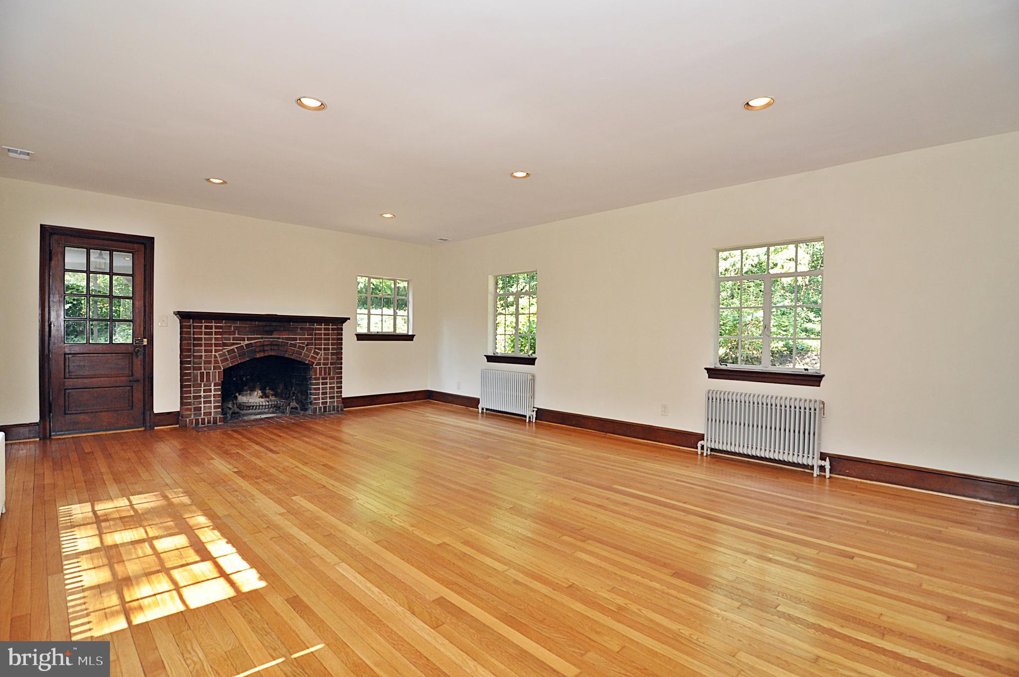 2721 South Arlington Ridge Road Arlington, VA 22202 - Photo 3 of 33 a view of empty room with wooden floor and fireplace