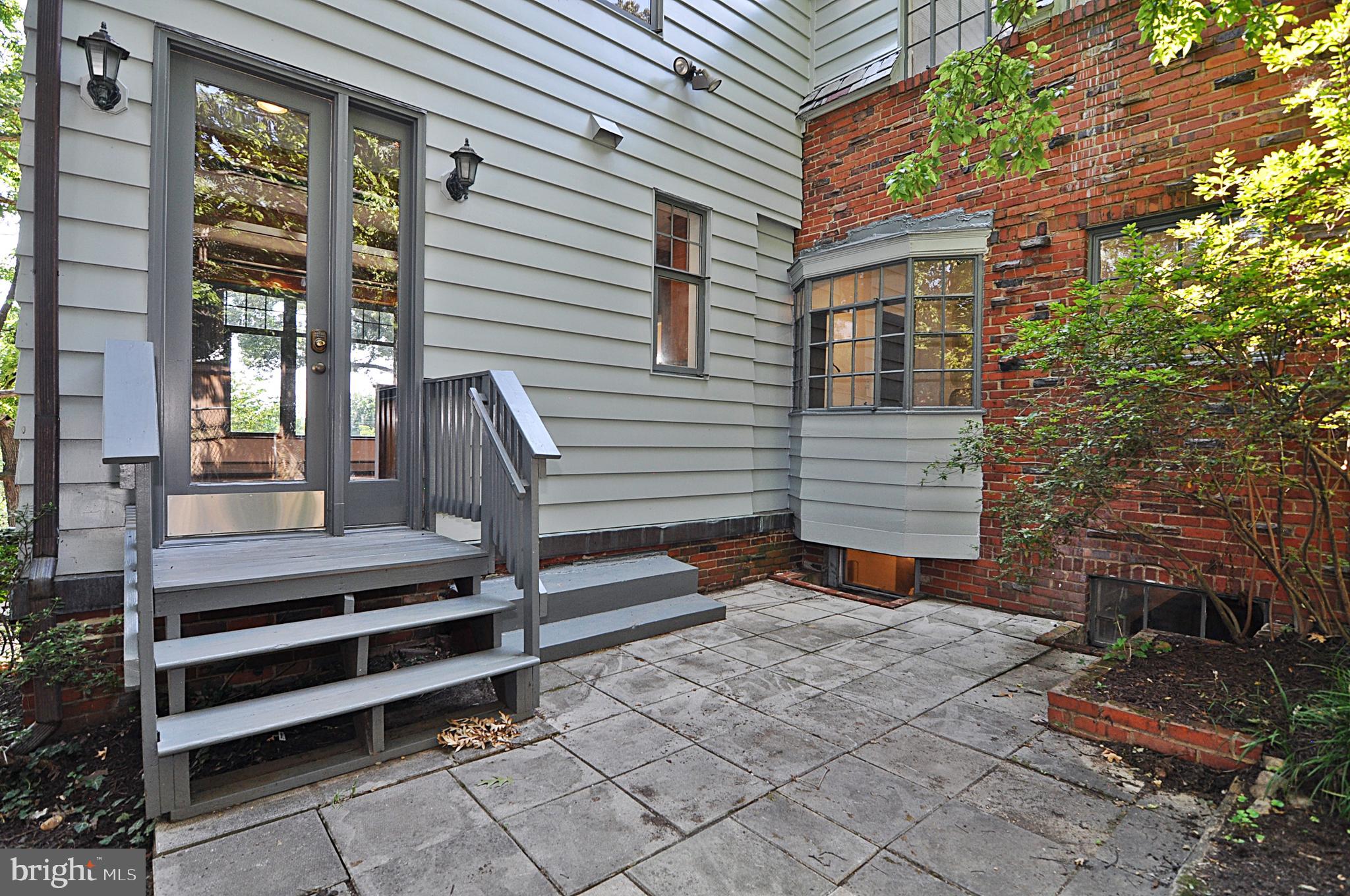 2721 South Arlington Ridge Road Arlington, VA 22202 - Photo 29 of 33 a backyard of a house with barbeque oven and brick wall