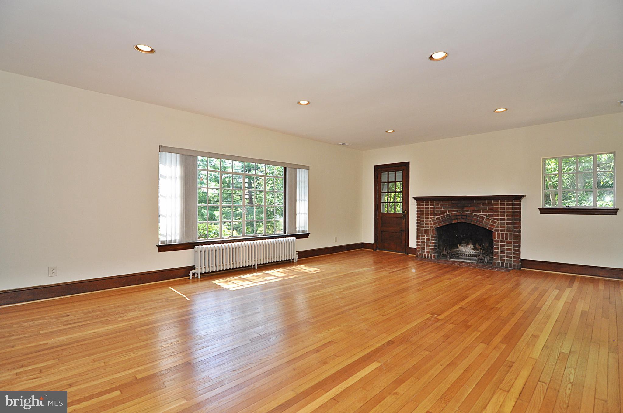 2721 South Arlington Ridge Road Arlington, VA 22202 - Photo 4 of 33 a view of empty room with wooden floor and fireplace