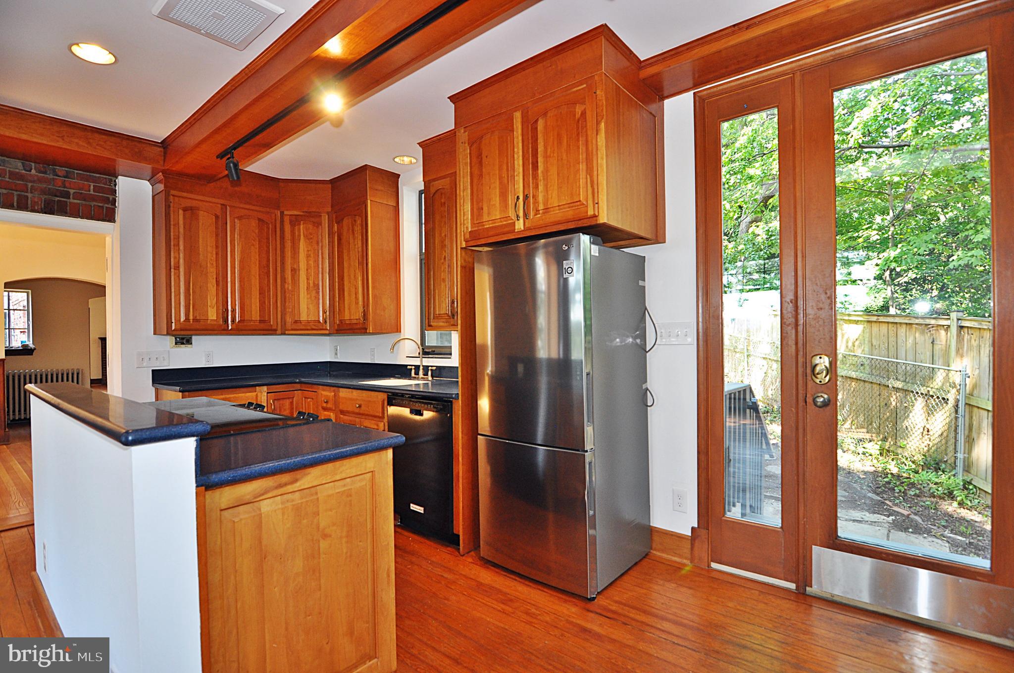 2721 South Arlington Ridge Road Arlington, VA 22202 - Photo 10 of 33 a kitchen with stainless steel appliances granite countertop a refrigerator a sink and wooden cabinets