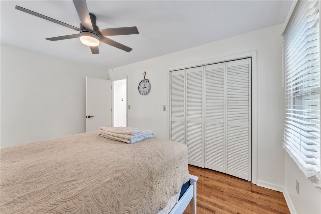 4416 Denver Cove Road Anderson, SC 29625 - Photo 16 of 31 A well-lit bedroom featuring hardwood floors and a modern ceiling fan, offering a comfortable personal retreat.