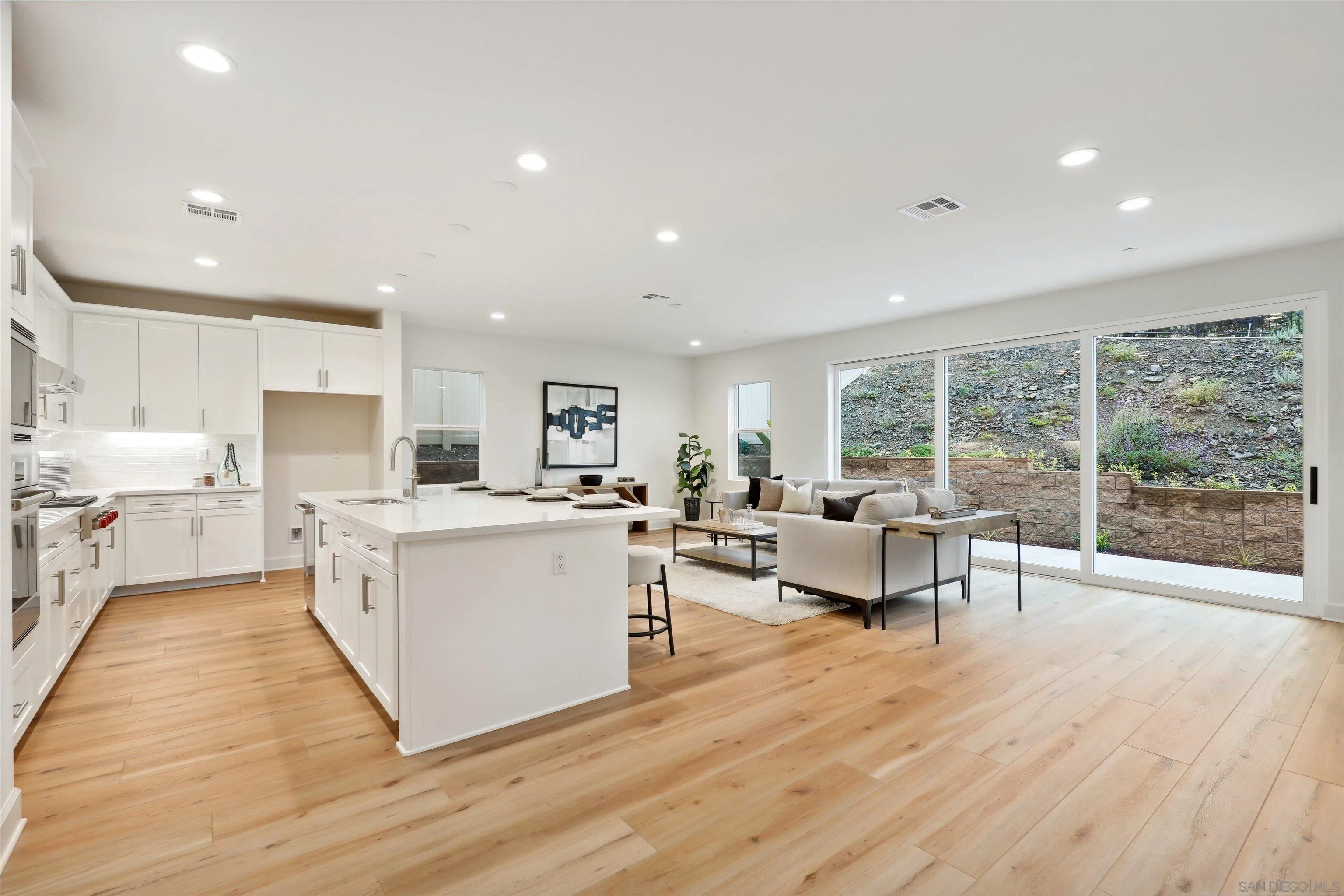929 Woodhaven Road San Marcos, CA 92069 - Photo 8 of 36 a large white kitchen with lots of counter space a sink and appliances