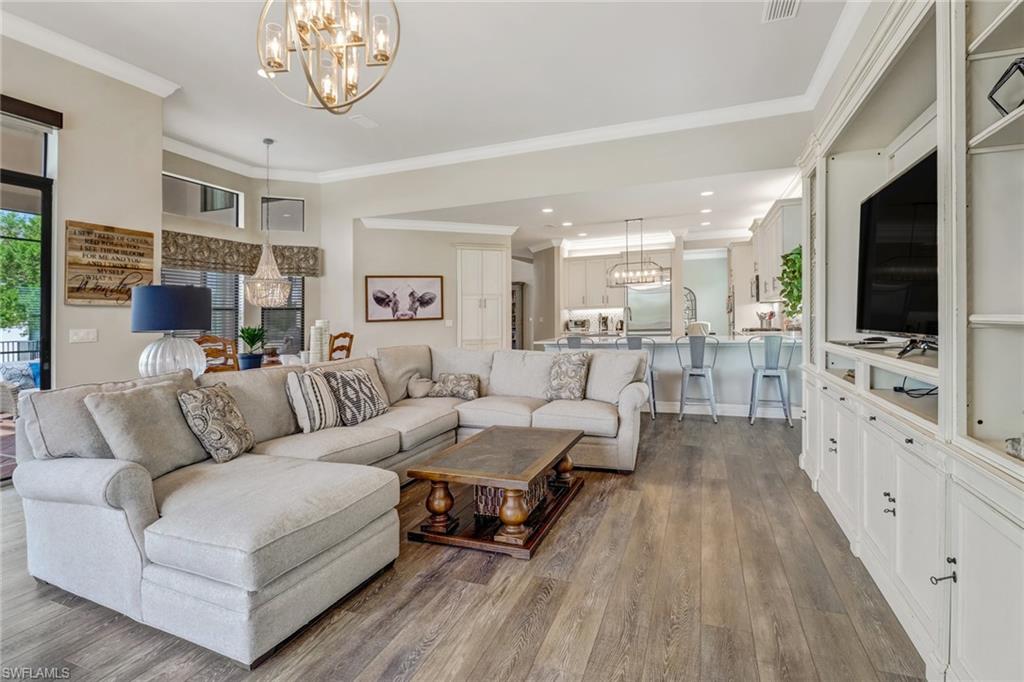 4663 Azalea Drive Naples, FL 34119 - Photo 11 of 34 a living room with furniture a flat screen tv and kitchen view