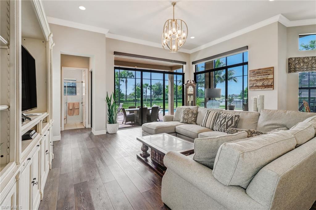 4663 Azalea Drive Naples, FL 34119 - Photo 12 of 34 a living room with furniture and a chandelier