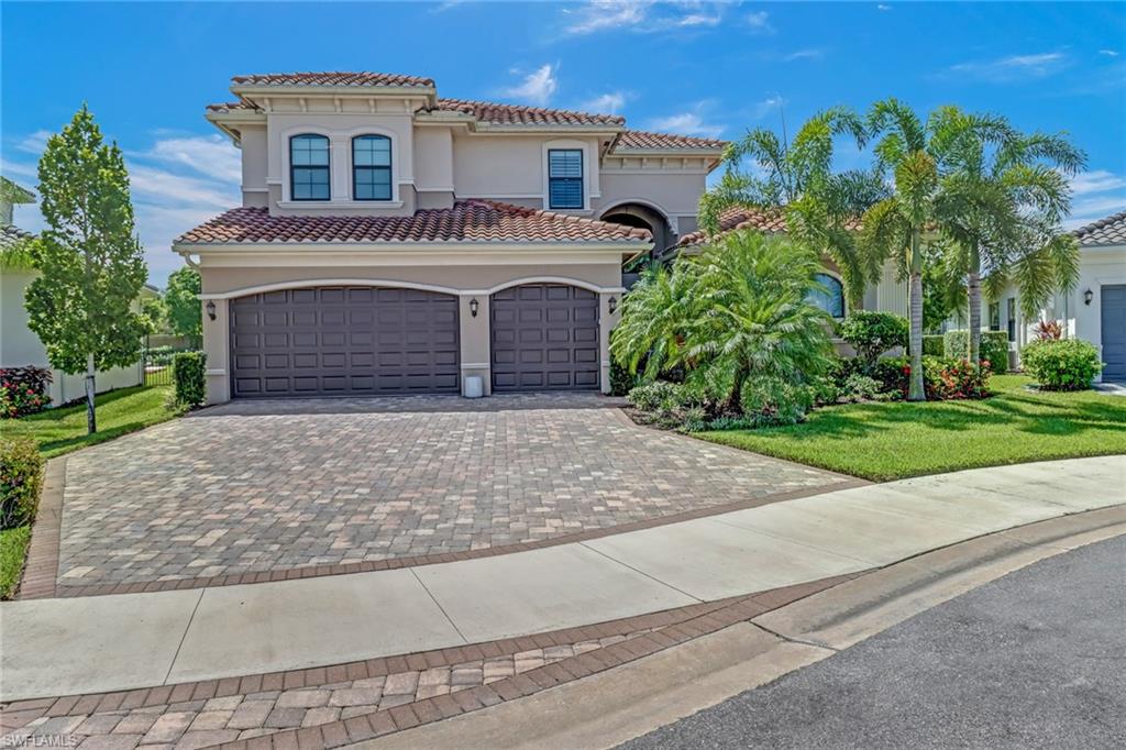 4663 Azalea Drive Naples, FL 34119 - Photo 2 of 34 a front view of a house with a garden