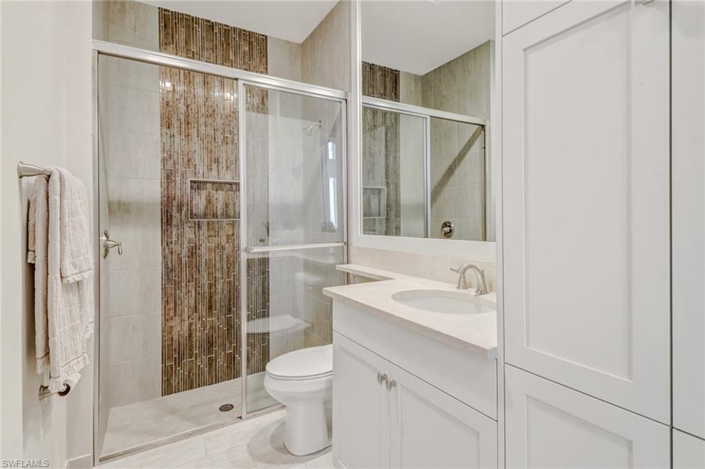 4663 Azalea Drive Naples, FL 34119 - Photo 21 of 34 a bathroom with a sink toilet and shower