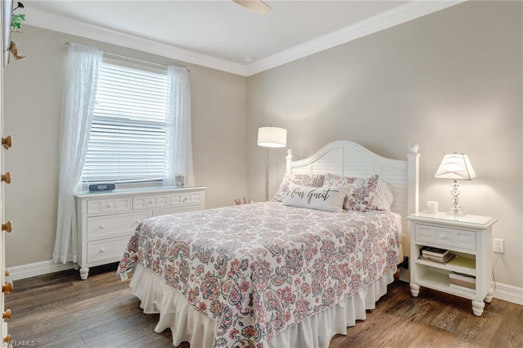 4663 Azalea Drive Naples, FL 34119 - Photo 24 of 34 a bedroom with a bed and a window