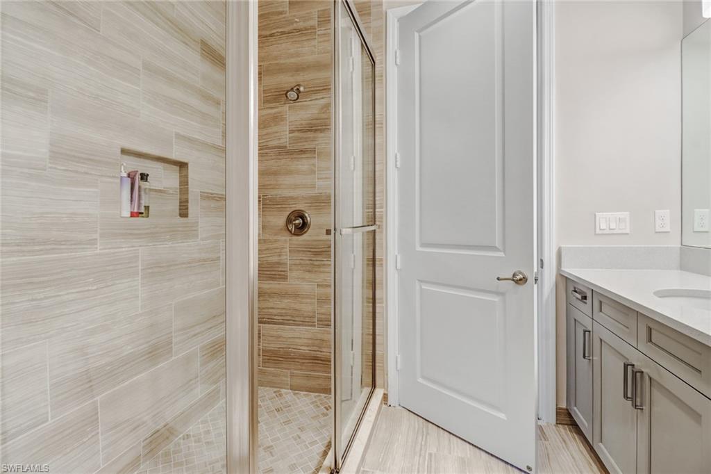 4663 Azalea Drive Naples, FL 34119 - Photo 25 of 34 a bathroom with a granite countertop sink and shower